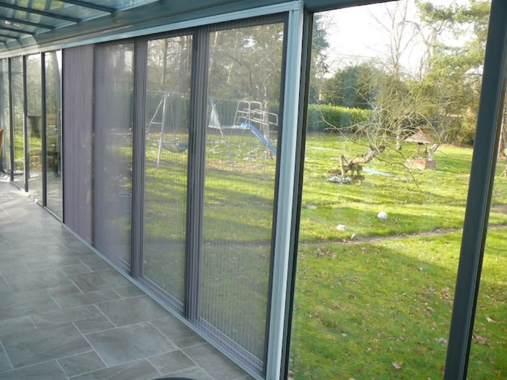 Bi-fold flyscreen fitted across a multi-panel garden room opening