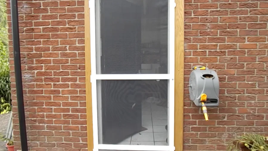 Commercial flyscreen door fitted to brick doorway